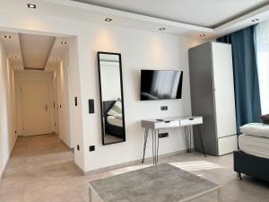 a living room with a mirror and a table at Aparts House - Balkon - Free Parking- WiFi - Kitchen in Essen