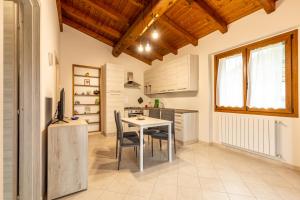 a kitchen with a table and chairs in a room at Chalet La Greta Vista Superiore in Firenzuola