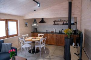 a kitchen and dining room with a table and chairs at domek Sybilla in Pieszyce