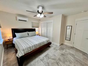 a bedroom with a bed and a ceiling fan at Newest Cottage Downtown. Pet Yes in Beaufort