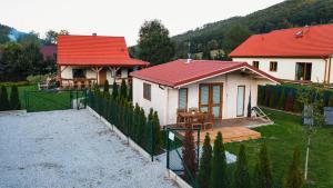 a small white house with a red roof at domek Sybilla in Pieszyce