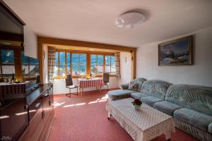 a living room with a couch and a table at Haus Daheim in Bad Hindelang