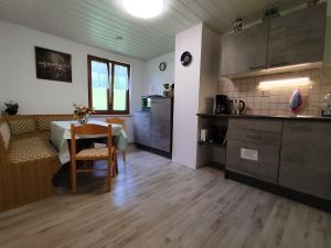 a kitchen and dining room with a table in a room at Haus Daheim in Bad Hindelang