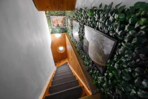 a staircase with a wall covered in green plants at Terminal Garden Apartman in Budapest