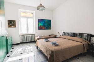 a bedroom with a bed and a window at palmaria suite -the duck nest in Genoa