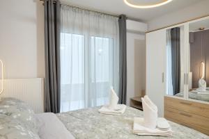 a bedroom with a bed and a large mirror at Cem's Luxury Apartment in Xanthi