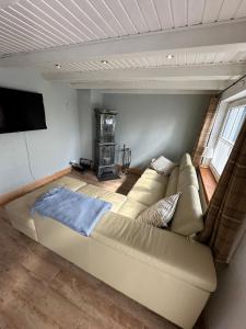 ein Wohnzimmer mit Sofa und Fernseher in der Unterkunft Little Blue Cottage #7 in Fehmarn