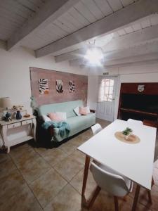 a living room with a bed and a table at Cabañas Seru in El Bolsón
