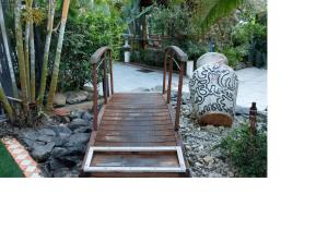 a wooden walkway with a large vase next to it at Appartement Bella in Vieux Bourg
