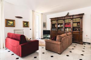 a living room with two chairs and a book shelf at palmaria suite -the duck nest in Genoa