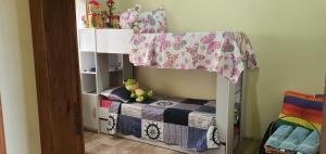 a bedroom with a bunk bed with a crib at Casa de Praia- Village Dunnas- Bal. Gaivota-SC in Balneário Gaivotas
