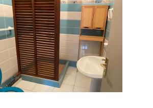 a bathroom with a toilet and a sink at Appartement Bella in Vieux Bourg +14 photos