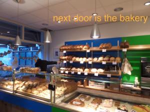 a bakery with a bunch of pastries on display at MAFF Top Studio Apartment in The Hague
