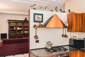 a kitchen with a counter with a stove top oven at palmaria suite -the duck nest in Genoa