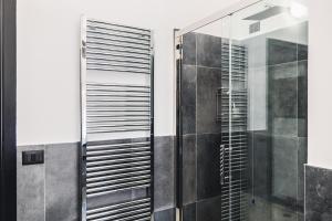 a shower with a glass door in a bathroom at palmaria suite -the duck nest in Genoa +19 photos