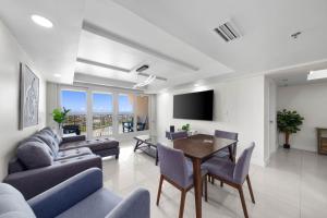 a living room with a couch and a table at Stunning Sunsets and SpaceX Views in South Padre Island