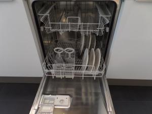 a dishwasher filled with lots of dishes and glasses at MAFF Top Studio Apartment in The Hague