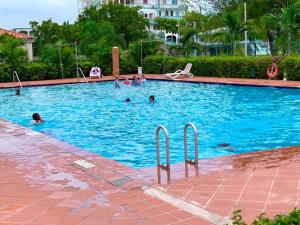 a group of people swimming in a swimming pool at Jolly Holiday Apartment 1-A in Jolly Harbour