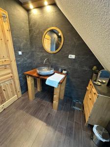 a bathroom with a sink and a mirror at Little Blue Cottage #7 in Fehmarn +33 photos