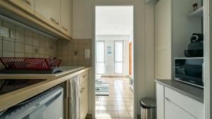 a kitchen with a sink and a microwave at Studio vue mer in Trévou-Tréguignec +3 photos