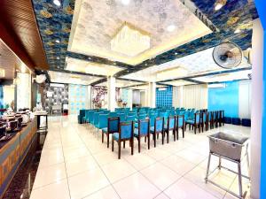 a dining room with blue tables and chairs at Hotel Rama in Gorakhpur