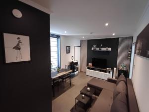 a living room with a couch and a table at City Apartment Paderborn Apartment 6 in Paderborn