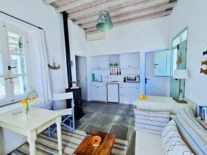 a living room with a couch and a table at Xenonas Sifnos in Faros