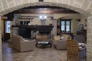 a living room with couches and a fireplace at Villa Sant' Andrea in Gubbio