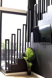 a television on a wall with a plant next to it at Wellness Villa Silente with spa area in Jalšovec