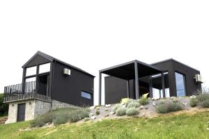 a black house on top of a hill at Wellness Villa Silente with spa area in Jalšovec