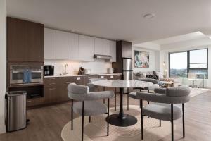 a kitchen with a table and chairs in a room at Upscale 1BR near MIT Harvard with Parking in Cambridge