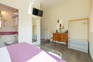 a bedroom with a bed and a sink and a mirror at Temple View FCollection Superior Relais in Rome +49 photos