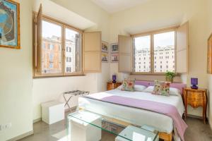a bedroom with a large bed and two windows at Temple View FCollection Superior Relais in Rome