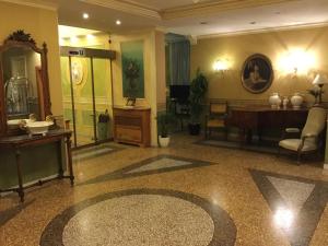 a living room with a table and a mirror at Hotel Bentivoglio Residenza D'Epoca in Bentivoglio