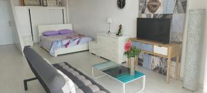 a living room with a tv and a bedroom at Cozy loft with Stunning Sea View in Palm-Mar