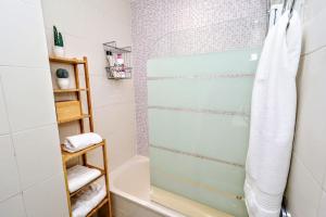 a bathroom with a shower with a glass door at Rincón de Sierra Nevada in Cenes de la Vega +19 photos