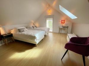 a living room with two beds and a couch at Gîte familial spacieux près de Villandry, avec jardin, pétanque et WIFI - FR-1-381-595 in Lignières-de-Touraine