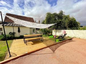 a wooden deck with a hammock and a bench at Gîte familial spacieux près de Villandry, avec jardin, pétanque et WIFI - FR-1-381-595 in Lignières-de-Touraine
