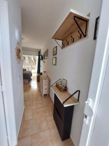 a hallway with a staircase with a counter and a room at Buenas Flores Tenerife in Costa Del Silencio