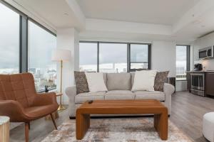 a living room with a couch and a coffee table at Central Penthouse Harvard MIT Spacious Gym & Work in Cambridge