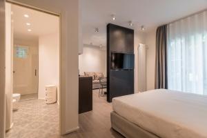 a hotel room with a bed and a bathroom at Mysuiteshome Apartments in Bologna