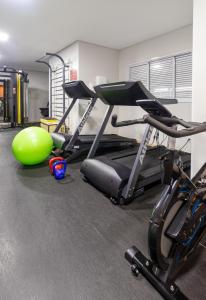 a gym with two exercise bikes and a fitness ball at PALMAS EXPERIENCE - APARTAMENTO CONTEMPORÂNEO, vista serra, na quadra do shopping in Palmas