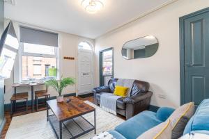 a living room with a couch and a table at Spacious Two Bed House in Headingley in Headingley