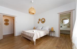 a white bedroom with a bed and a mirror at 4 Bedroom Cozy Home In Krusevo in Kruševo