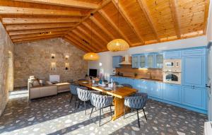 a kitchen with blue cabinets and a wooden ceiling at 4 Bedroom Cozy Home In Krusevo in Kruševo