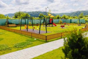 a park with a playground with a play equipment at Dominic Junior Apartment Sighisoara in Sighişoara