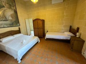 Postel nebo postele na pokoji v ubytování Ta Speranza Farmhouse B&B