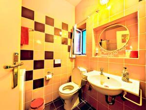 a bathroom with a toilet and a sink and a mirror at Ύδρα ivY in Hydra
