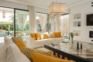 a living room with a couch and a glass table at Villa Netumia in Marrakesh