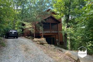 a car parked in front of a log cabin at Tree Top Hideaway - Private with Games Firepit More in Blue Ridge
